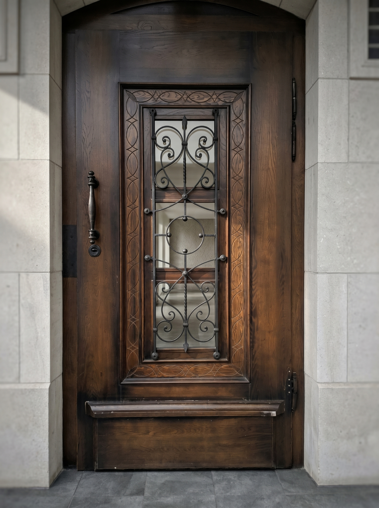 Hand-carved oak entrance door with wrought iron grille